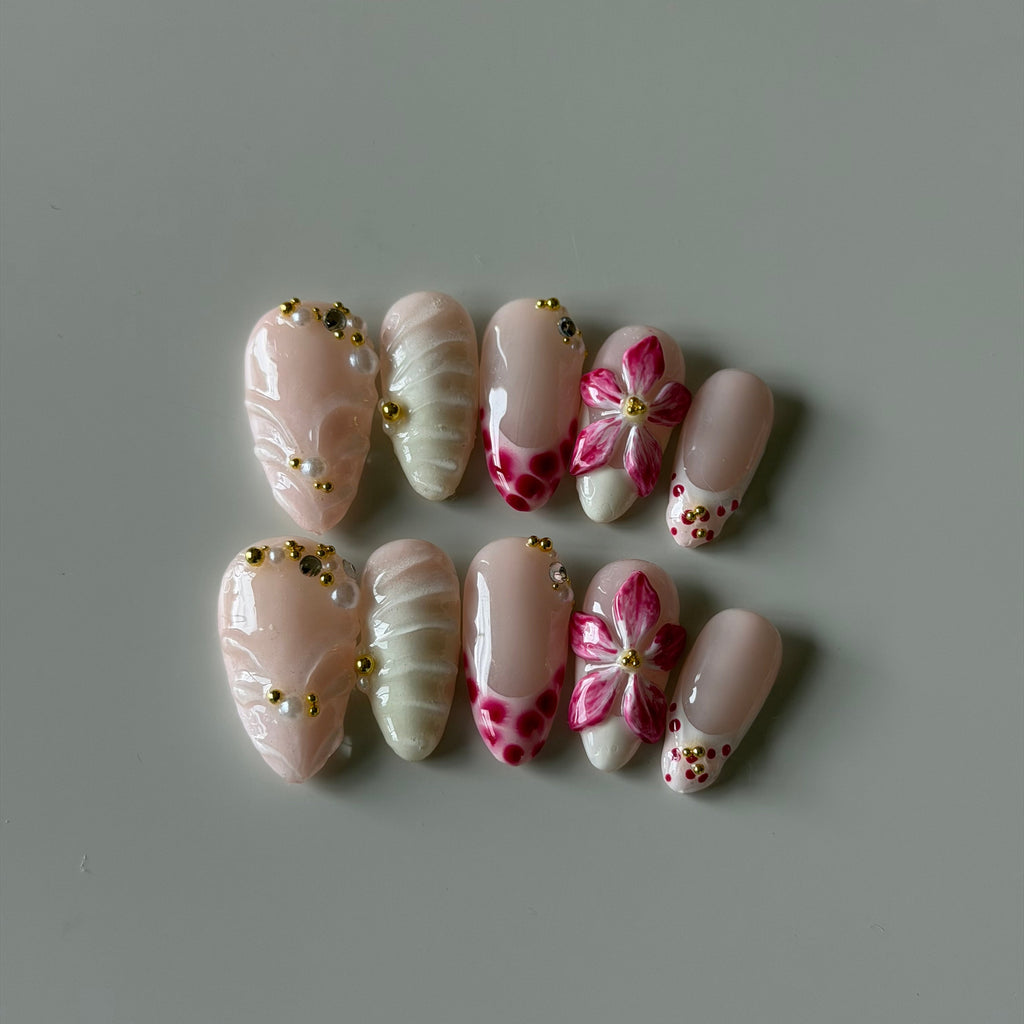 Blue and blush custom press-on nails with hand-painted characters, gold chains, and crystal accents