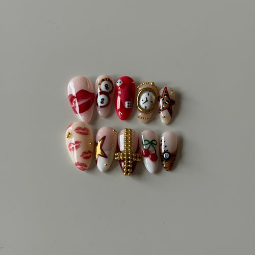 Nude hand-painted press-on nails with fine gold outlines and butterfly designs